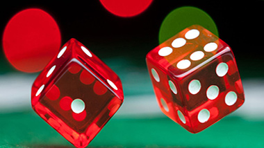 pair of red dice on green felt gaming table